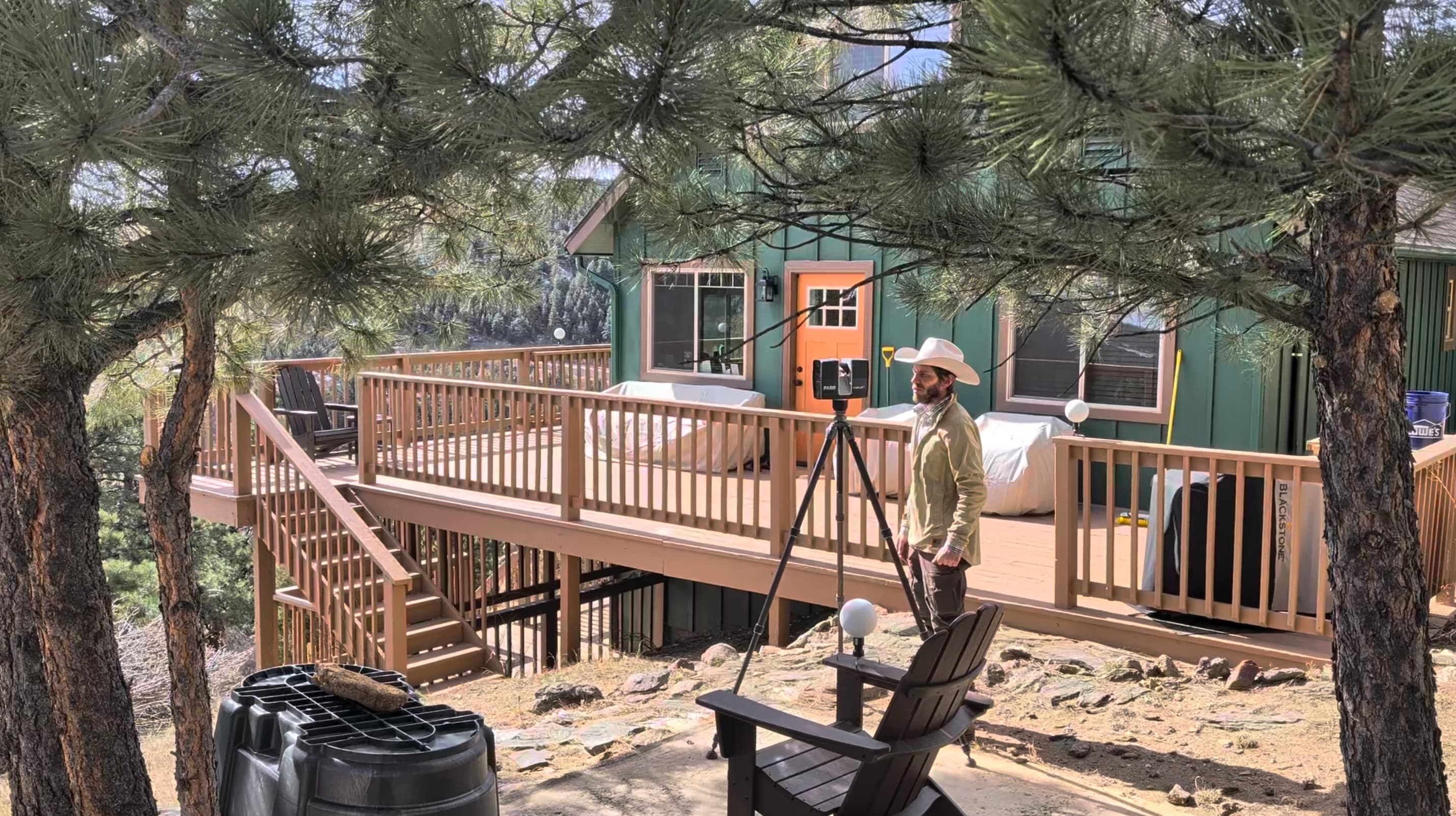 A SpearPoint Scans technician setting up a LiDAR scanner on a tripod at a residential job site